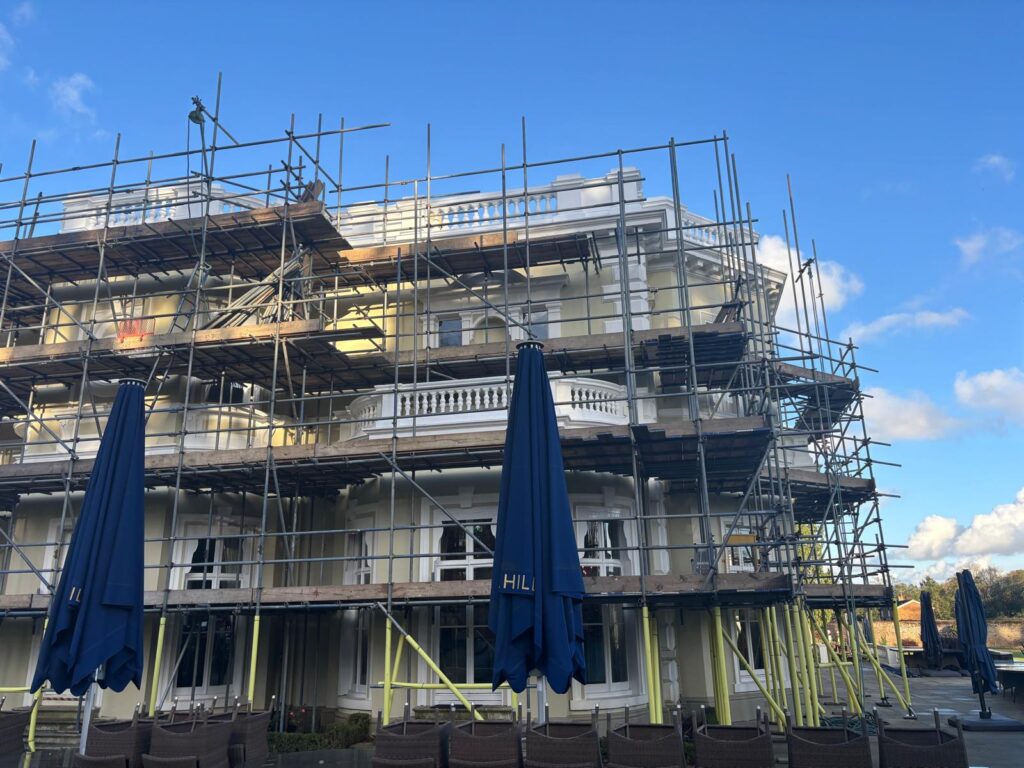 Scaffolding providing access around balconies and architectural features at the rear of the clubhouse